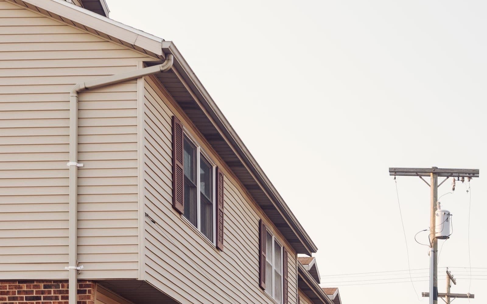 Suburban houses with siding and front lawns